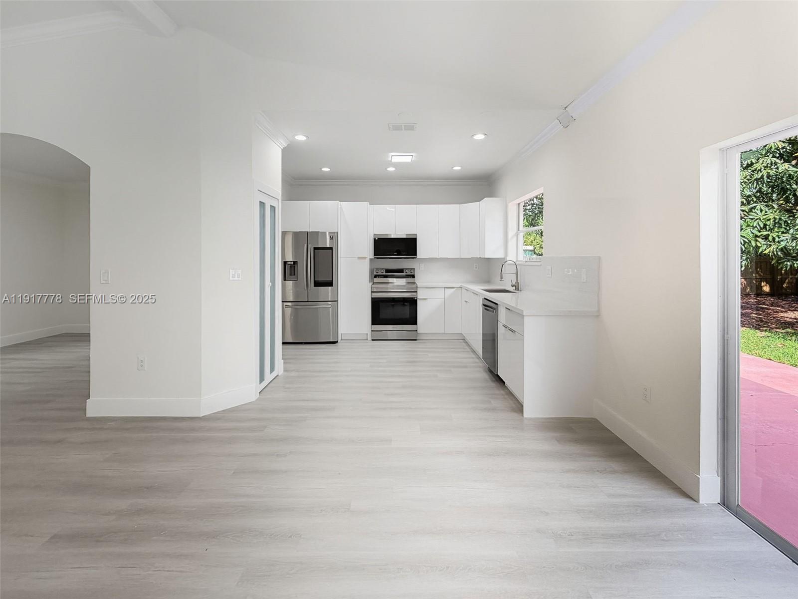 19601 Southwest 128th Court Miami, FL 33177 - Photo 15 of 59 a open kitchen with white cabinets and stainless steel appliances
