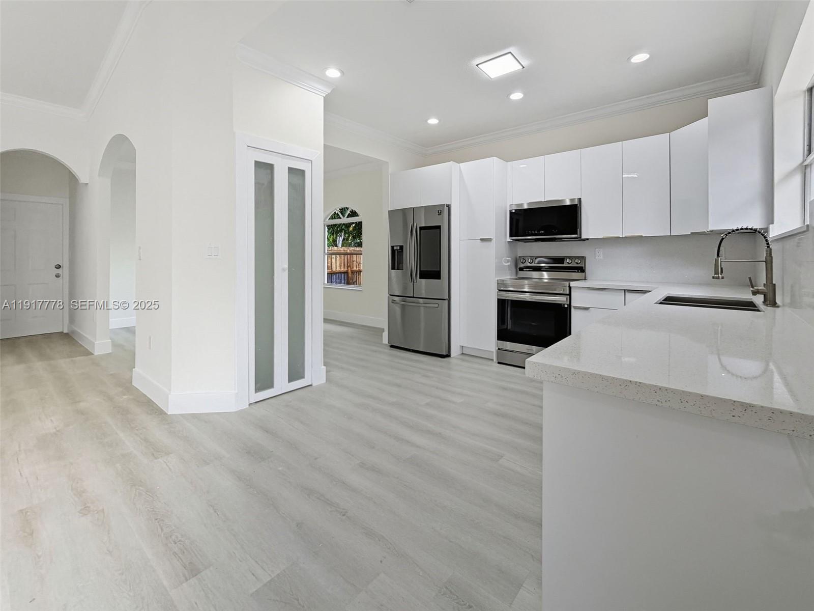 19601 Southwest 128th Court Miami, FL 33177 - Photo 18 of 59 a kitchen with stainless steel appliances a refrigerator a sink a stove top oven a refrigerator and cabinets