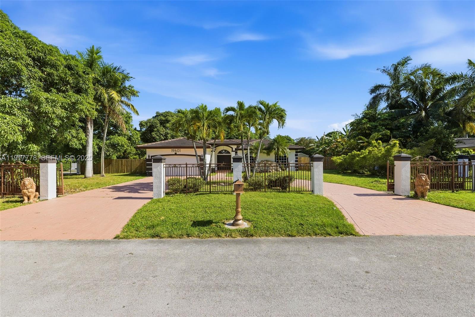 19601 Southwest 128th Court Miami, FL 33177 - Photo 2 of 59 a house view with a garden space