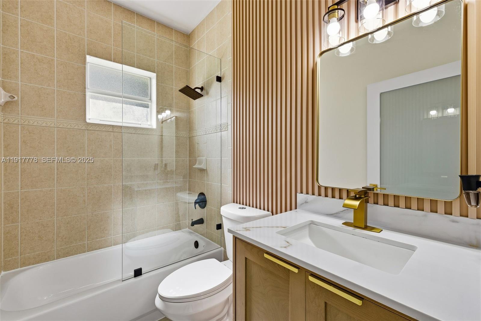 19601 Southwest 128th Court Miami, FL 33177 - Photo 24 of 59 a bathroom with a granite countertop sink toilet and shower