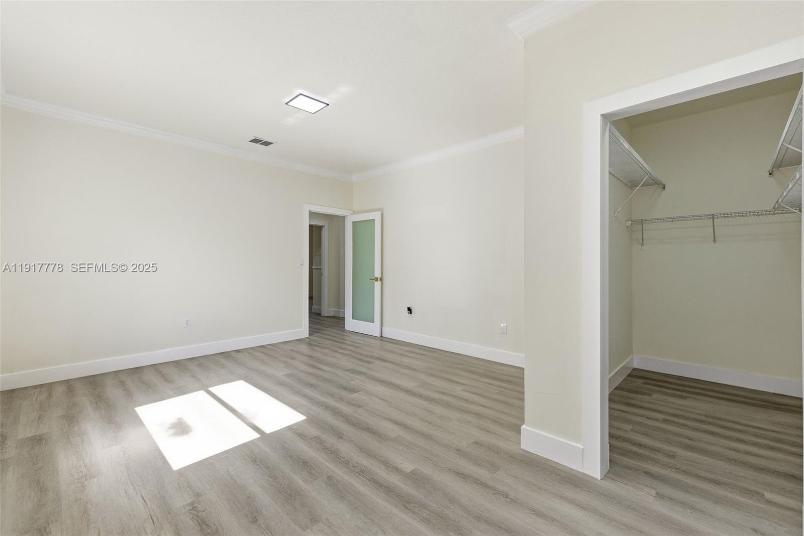 19601 Southwest 128th Court Miami, FL 33177 - Photo 27 of 59 an empty room with wooden floor and windows