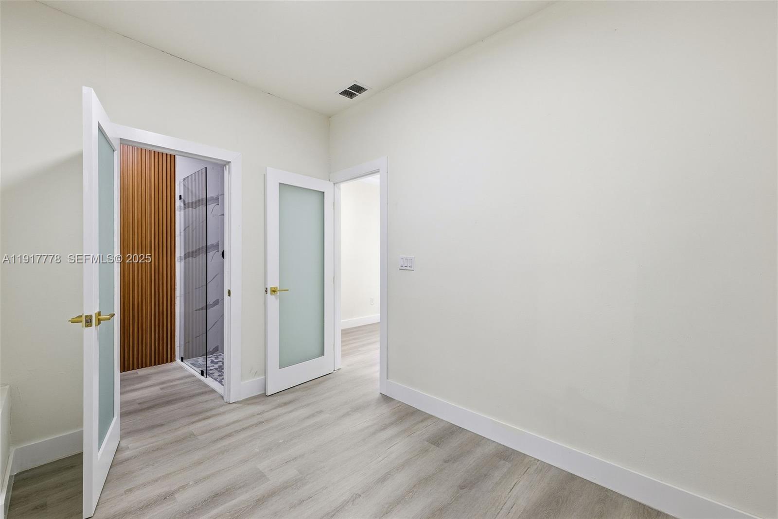 19601 Southwest 128th Court Miami, FL 33177 - Photo 30 of 59 a view of an empty room with wooden floor and closet