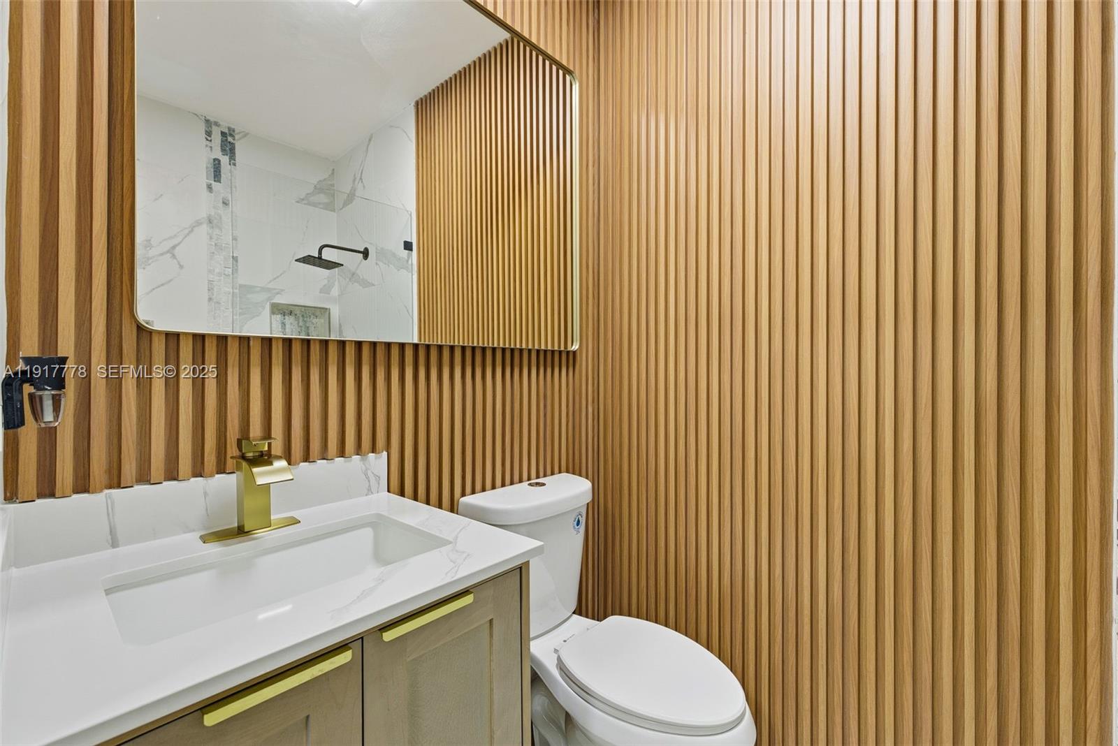 19601 Southwest 128th Court Miami, FL 33177 - Photo 32 of 59 a bathroom with a sink a toilet and mirror