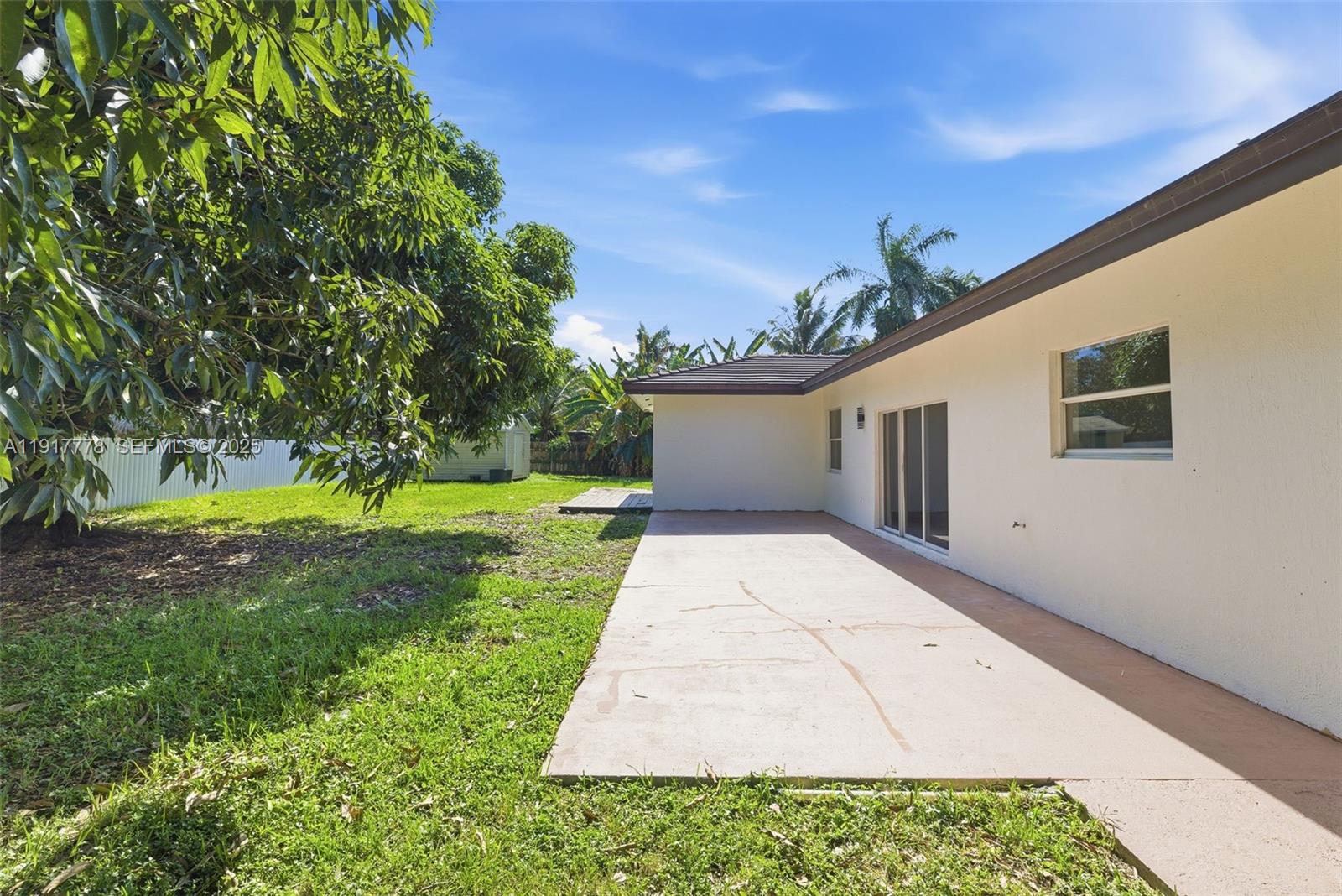 19601 Southwest 128th Court Miami, FL 33177 - Photo 34 of 59 a backyard of a house with yard and outdoor seating