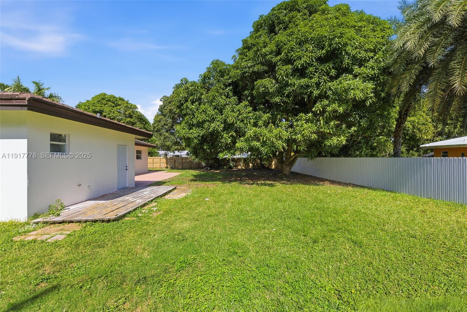 19601 Southwest 128th Court Miami, FL 33177 - Photo 38 of 59 a backyard of a house with plants and tree