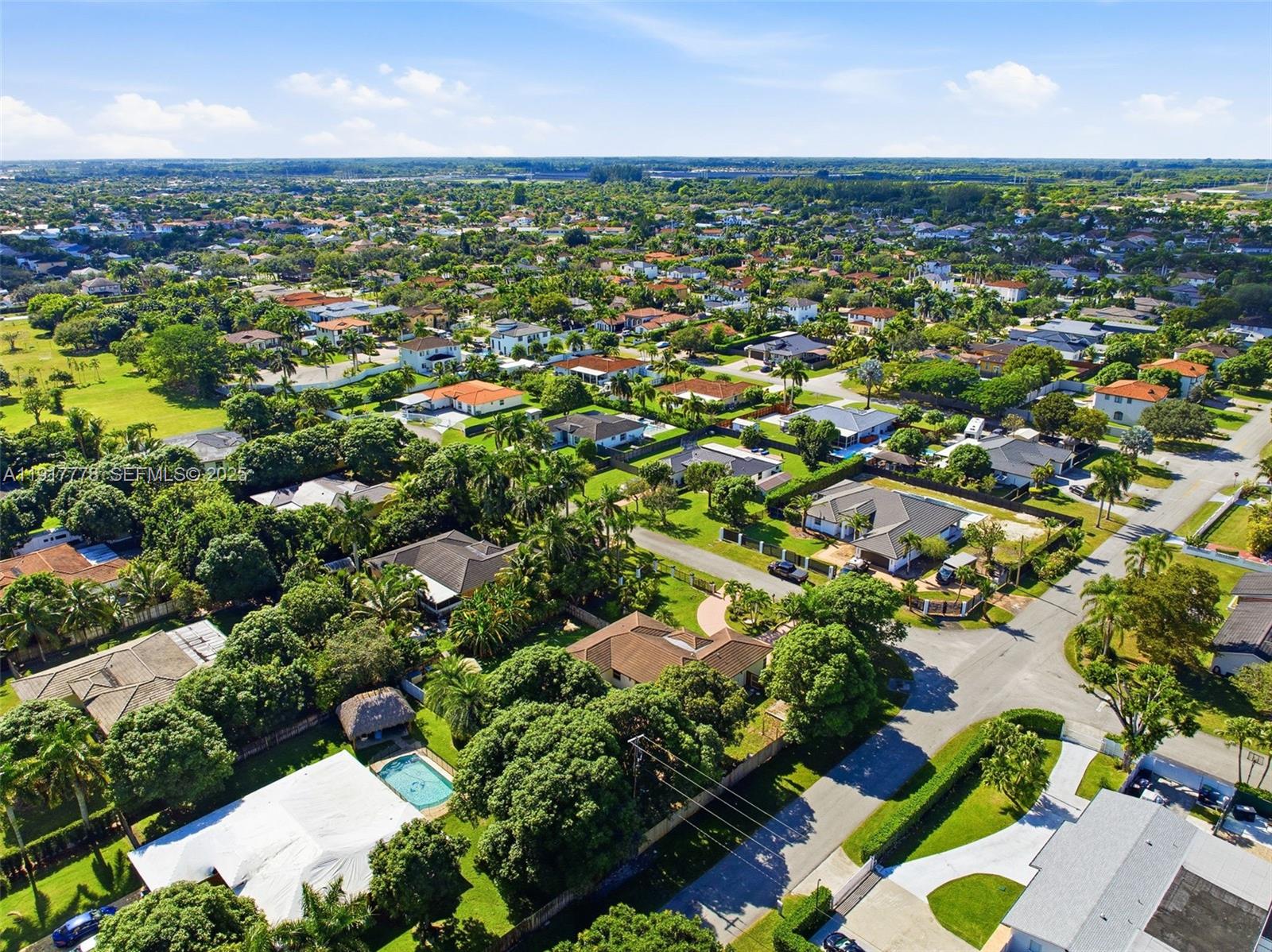 19601 Southwest 128th Court Miami, FL 33177 - Photo 51 of 59 an aerial view of residential houses with outdoor space and trees