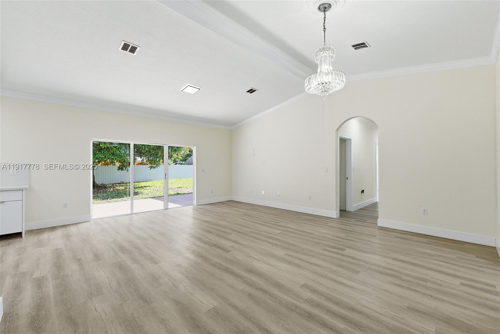 19601 Southwest 128th Court Miami, FL 33177 - Photo 8 of 59 a view of an empty room with a window and wooden floor