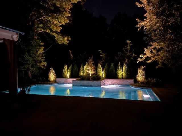 650 Bushchat Lane Collierville, TN 38017 - Photo 6 of 40 Pool at night featuring an outdoor pool and a patio