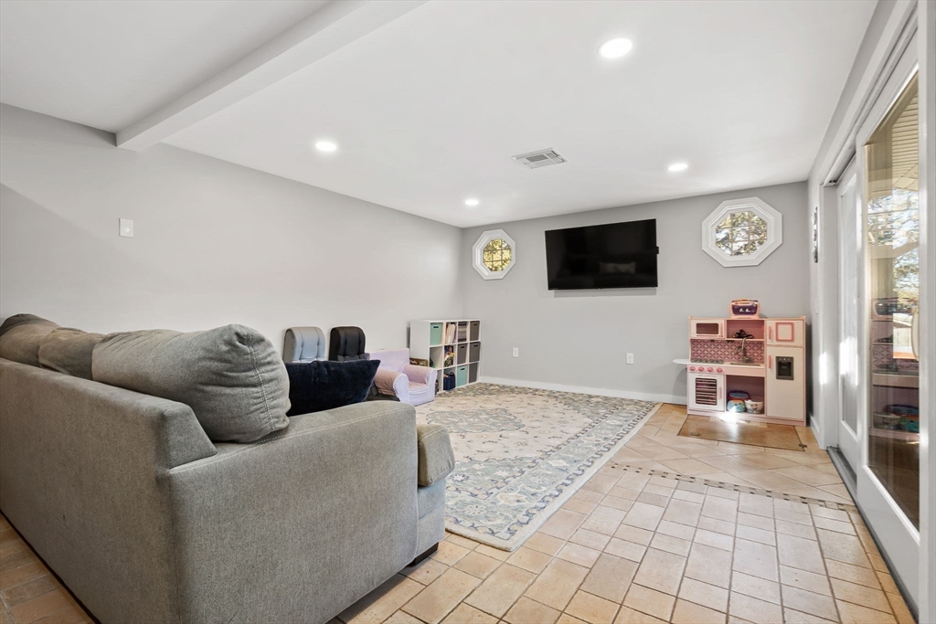 43 Colgate Road Beverly, MA 01915 - Photo 13 of 27 a living room with furniture and a flat screen tv