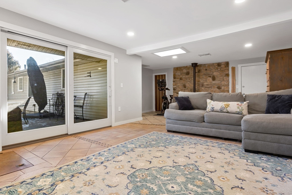 43 Colgate Road Beverly, MA 01915 - Photo 16 of 27 a living room with furniture and a glass door shower
