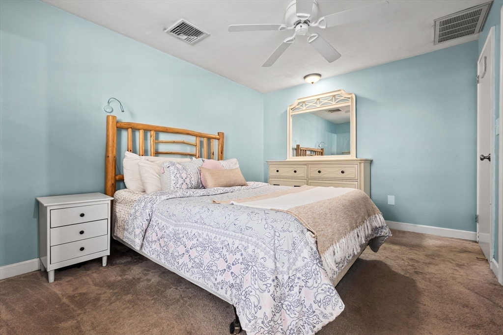 43 Colgate Road Beverly, MA 01915 - Photo 17 of 27 a bedroom with a bed and a chandelier