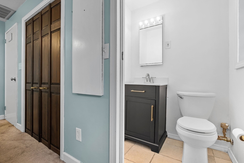43 Colgate Road Beverly, MA 01915 - Photo 19 of 27 a bathroom with a toilet a sink and mirror