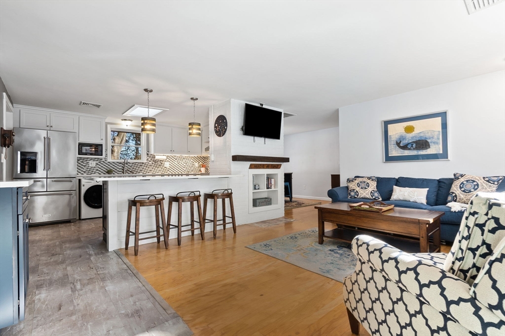 43 Colgate Road Beverly, MA 01915 - Photo 4 of 27 a living room with fireplace furniture and a flat screen tv
