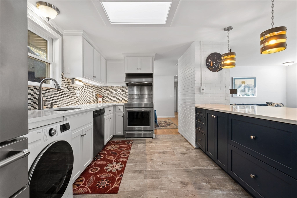 43 Colgate Road Beverly, MA 01915 - Photo 6 of 27 a kitchen with stainless steel appliances kitchen island granite countertop a stove and a sink