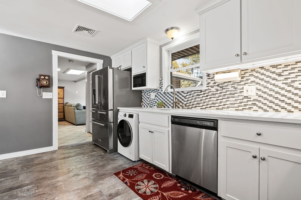 43 Colgate Road Beverly, MA 01915 - Photo 8 of 27 a kitchen with stainless steel appliances granite countertop a sink stove and refrigerator
