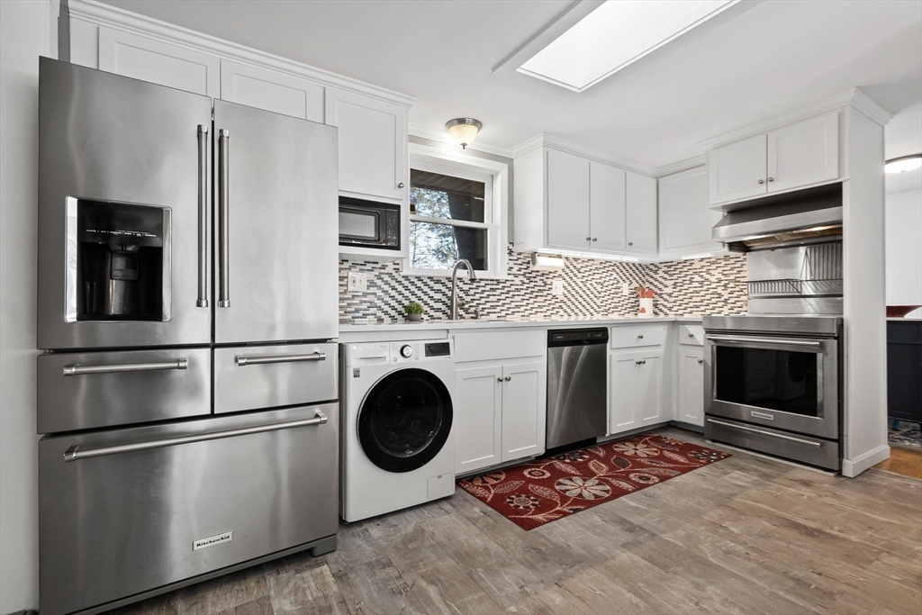 43 Colgate Road Beverly, MA 01915 - Photo 9 of 27 a kitchen with stainless steel appliances and white cabinets
