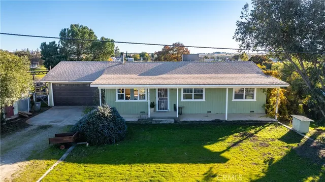 a aerial view of a house with a yard table and chairs