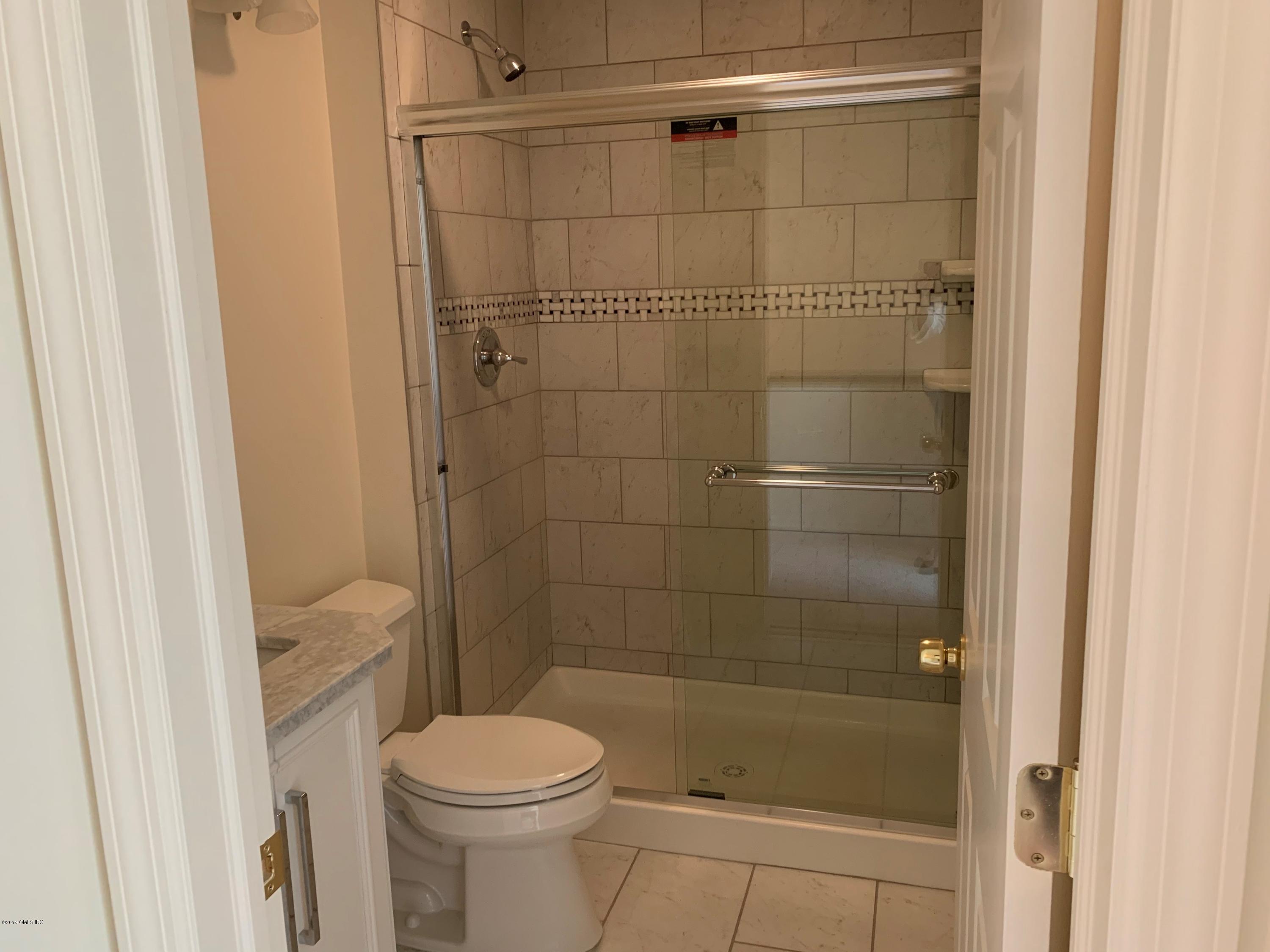 9 River Road, Unit 415 Cos Cob, CT 06807 - Photo 6 of 10 a bathroom with a shower a toilet and a sink