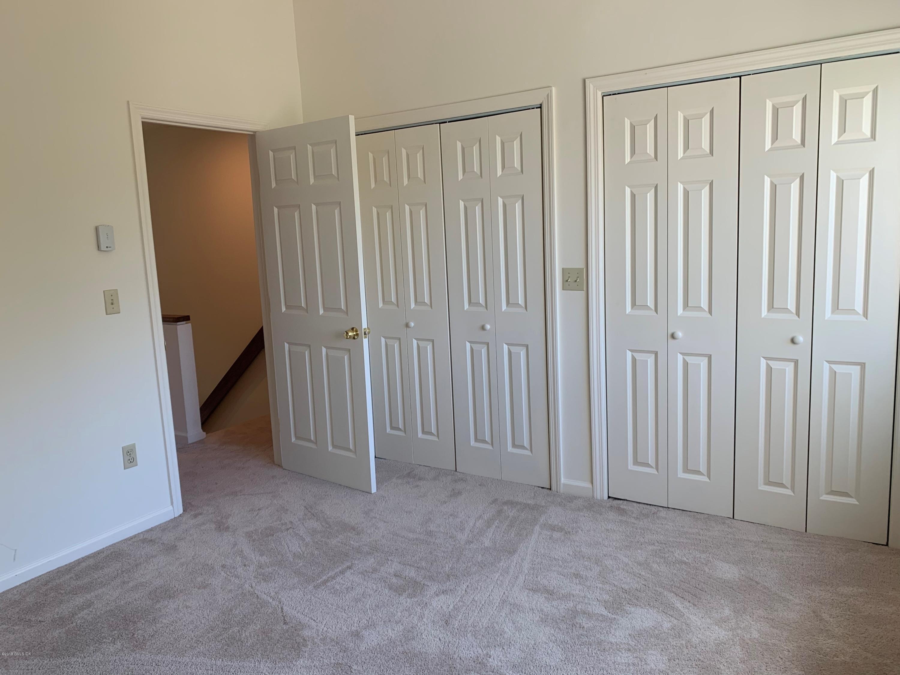 9 River Road, Unit 415 Cos Cob, CT 06807 - Photo 7 of 10 an empty room with a hallway