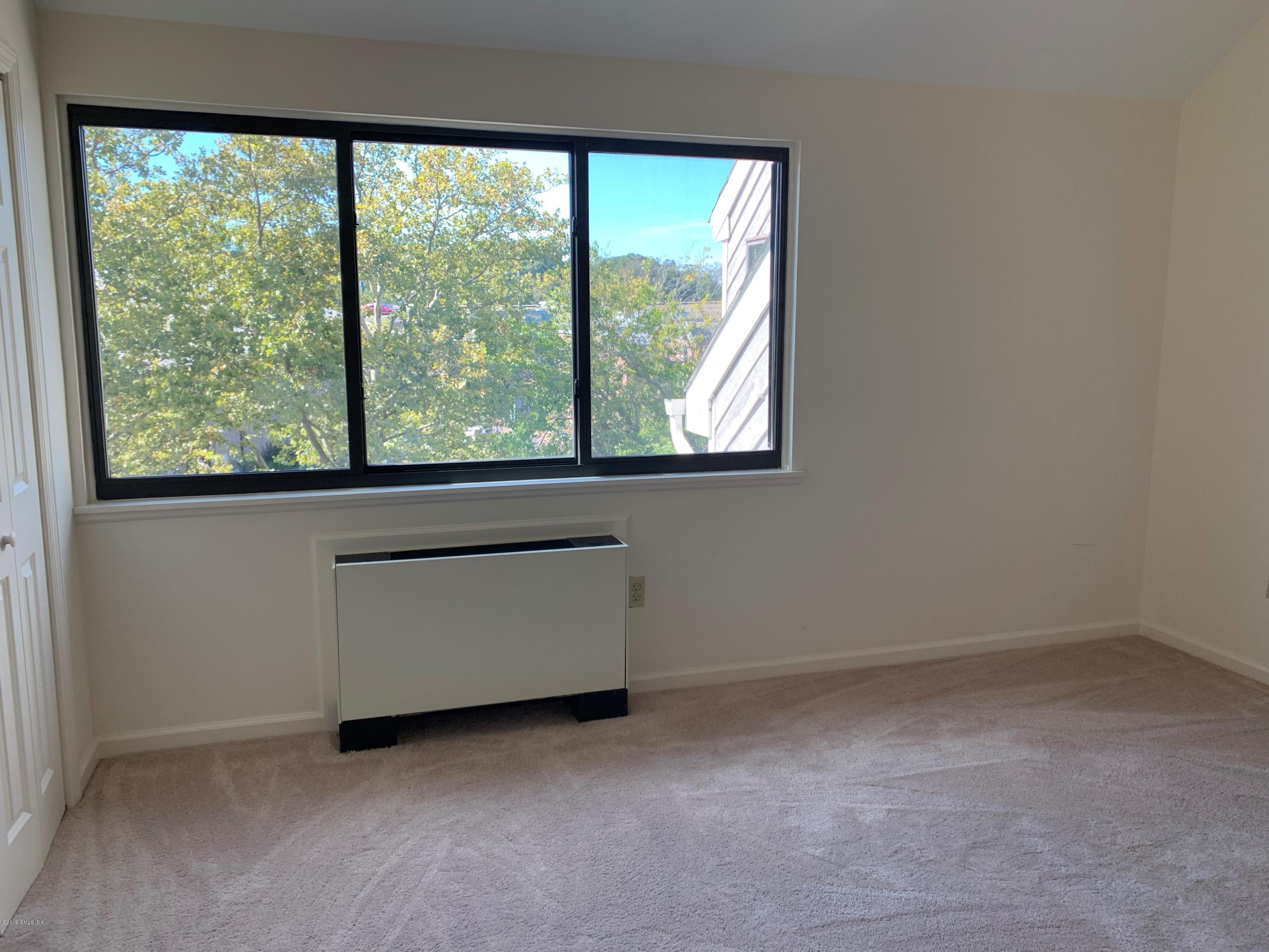 9 River Road, Unit 415 Cos Cob, CT 06807 - Photo 8 of 10 an empty room with a window
