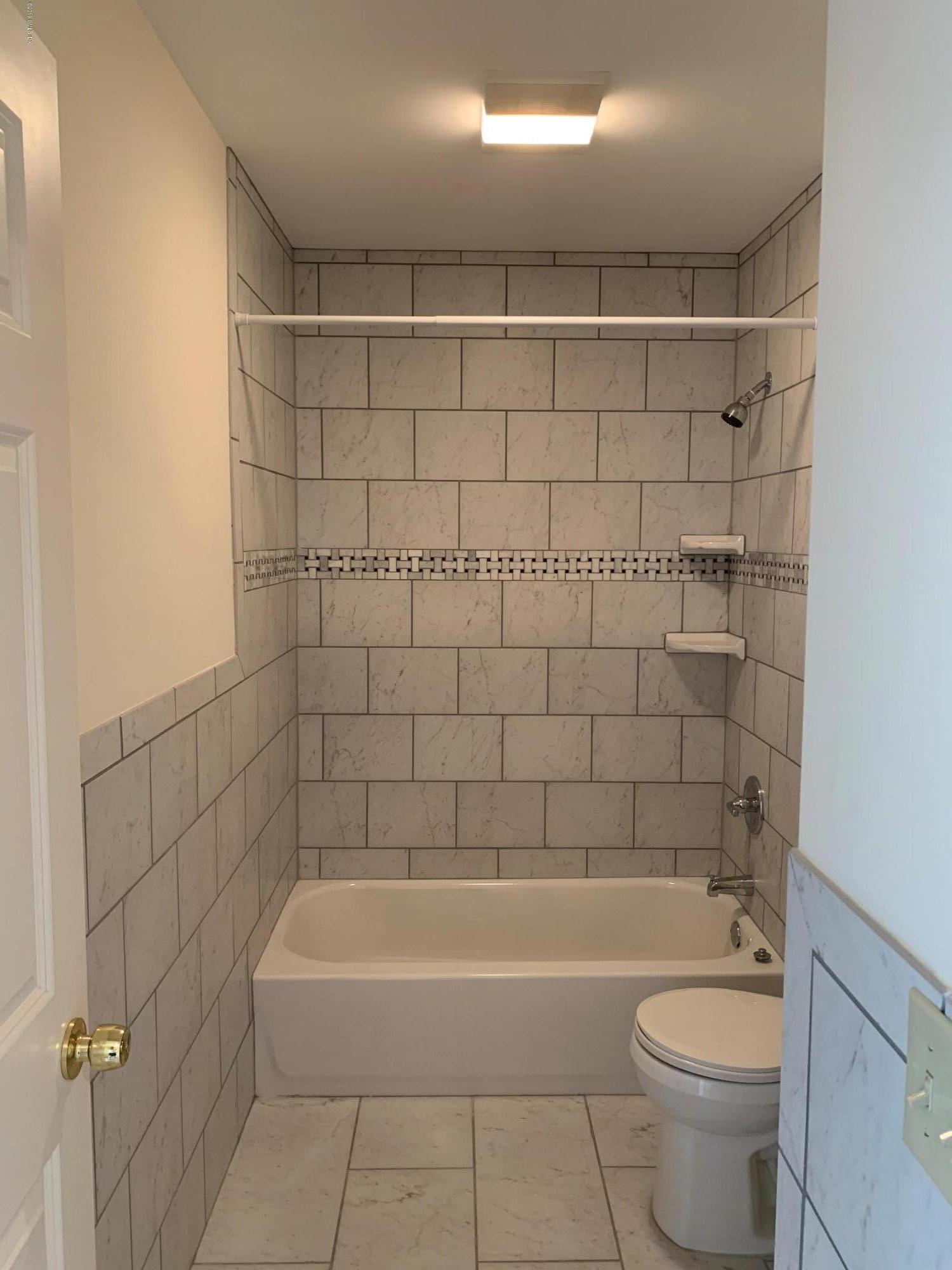 9 River Road, Unit 415 Cos Cob, CT 06807 - Photo 9 of 10 a bathroom with a bathtub and a toilet