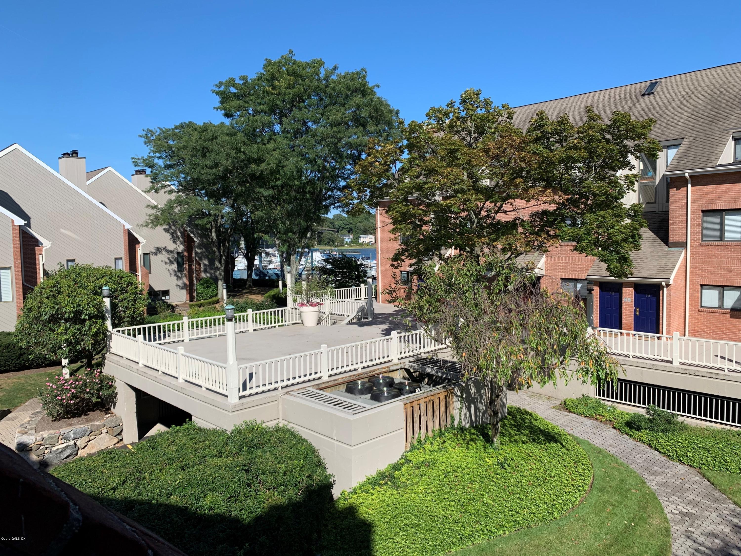 9 River Road, Unit 415 Cos Cob, CT 06807 - Photo 10 of 10 a view of a house with backyard and sitting area