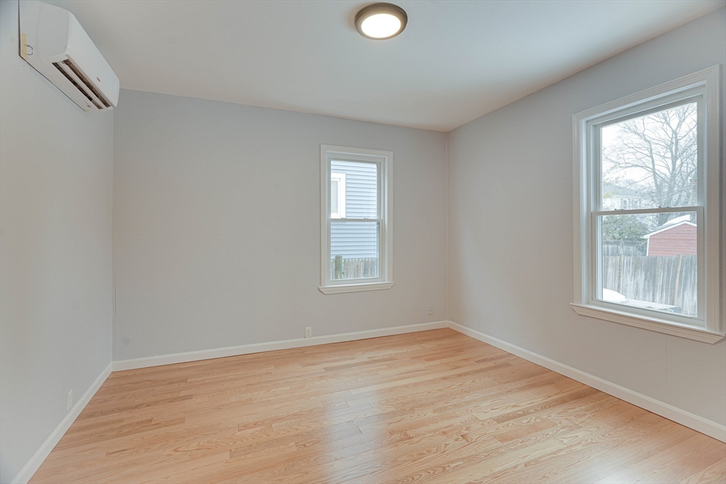 24 Dunlap Street Salem, MA 01970 - Photo 11 of 41 an empty room with wooden floor and windows