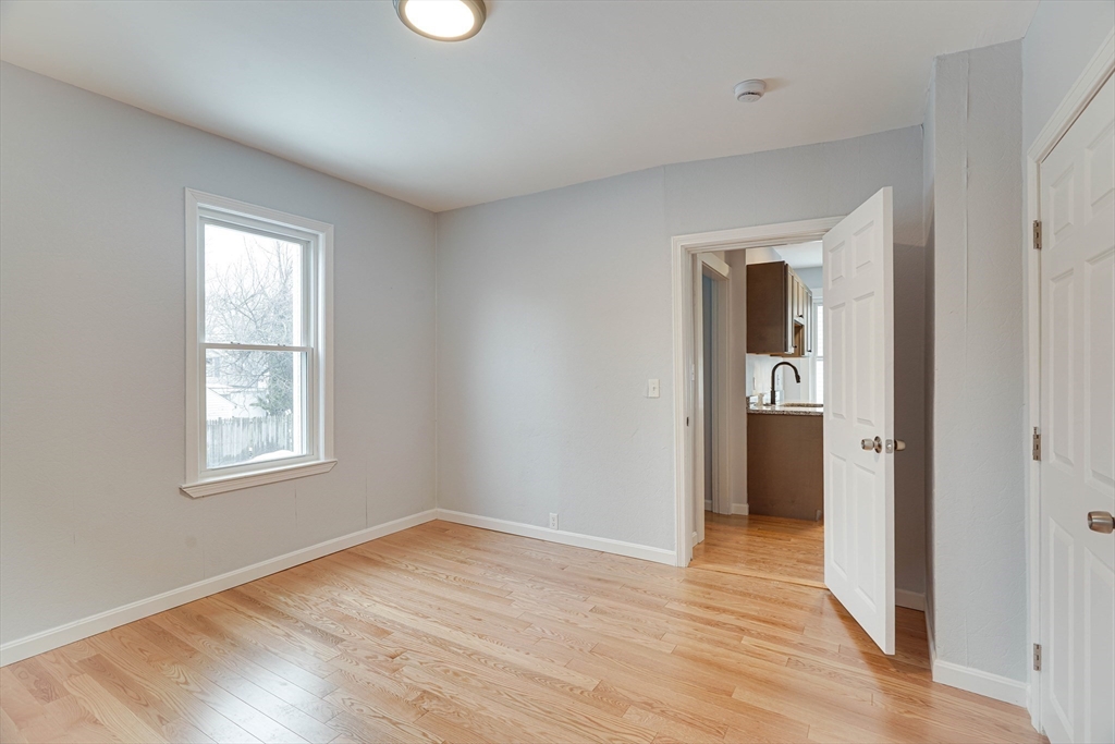 24 Dunlap Street Salem, MA 01970 - Photo 12 of 41 a view of an empty room with wooden floor and a window
