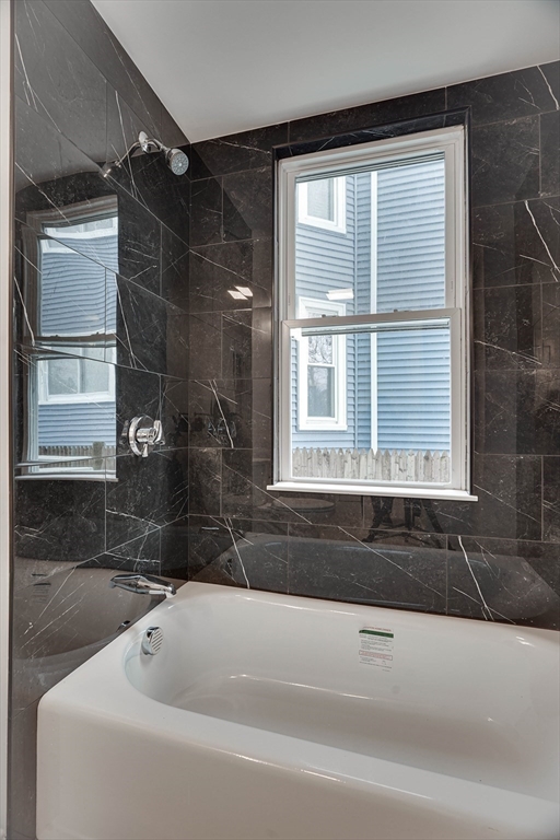 24 Dunlap Street Salem, MA 01970 - Photo 17 of 41 a bathroom with a bathtub and a shower