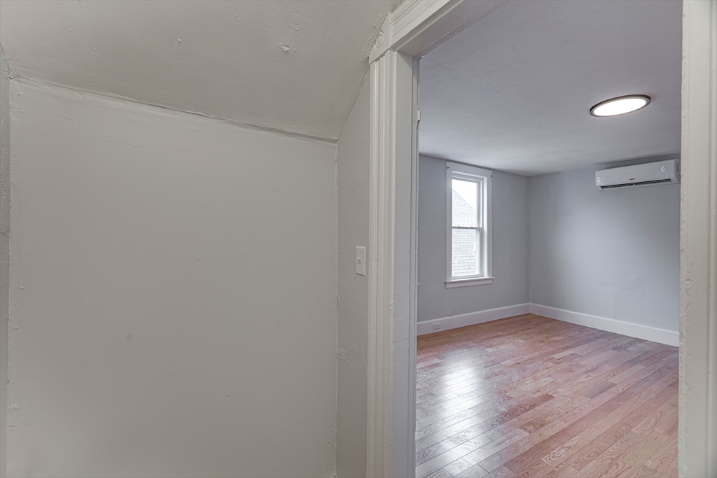 24 Dunlap Street Salem, MA 01970 - Photo 30 of 41 a view of an empty room with wooden floor and a window