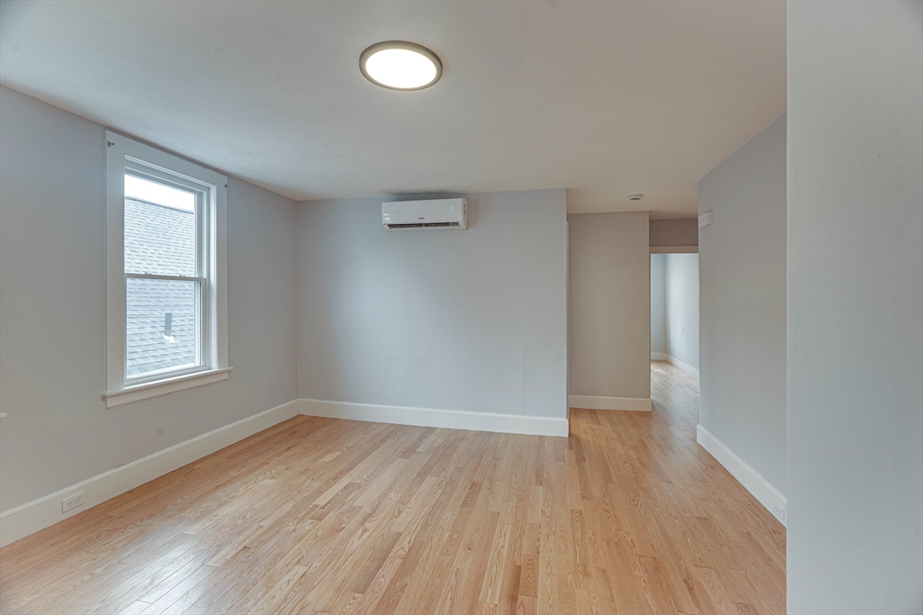 24 Dunlap Street Salem, MA 01970 - Photo 31 of 41 an empty room with wooden floor and windows