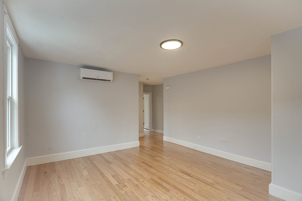 24 Dunlap Street Salem, MA 01970 - Photo 32 of 41 an empty room with wooden floor and windows