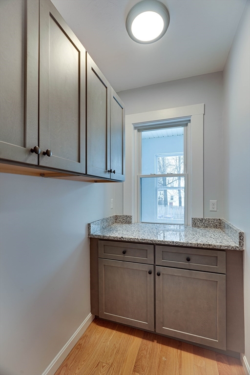 24 Dunlap Street Salem, MA 01970 - Photo 9 of 41 a kitchen with granite countertop cabinets and window