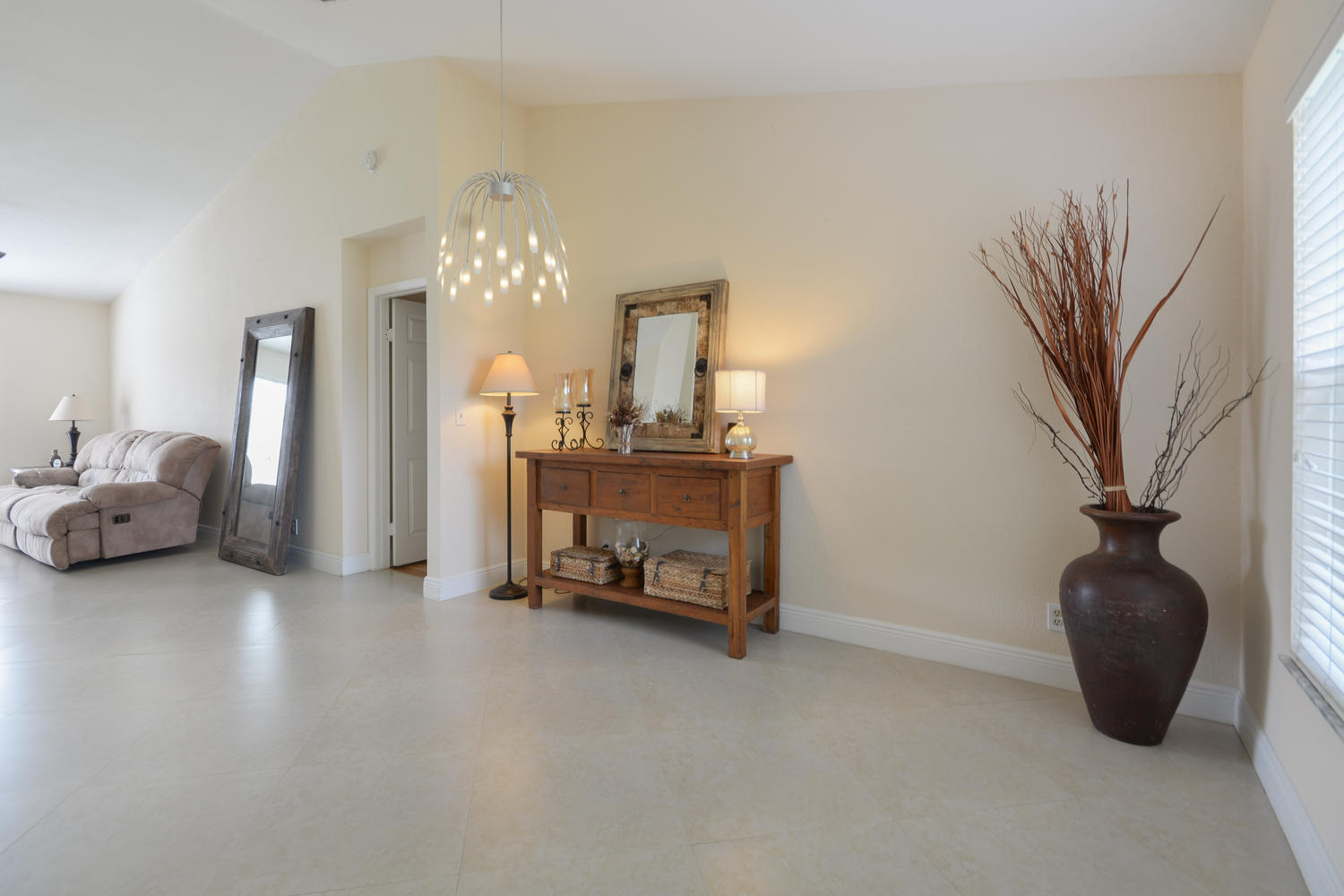 22166 Appleton Drive Boca Raton, FL 33428 - Photo 13 of 47 a living room with furniture a chandelier and a chair