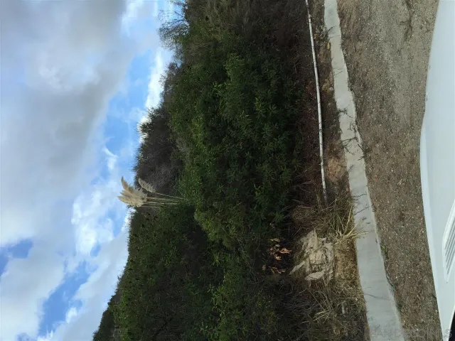 a view of city street with a car parked on the road