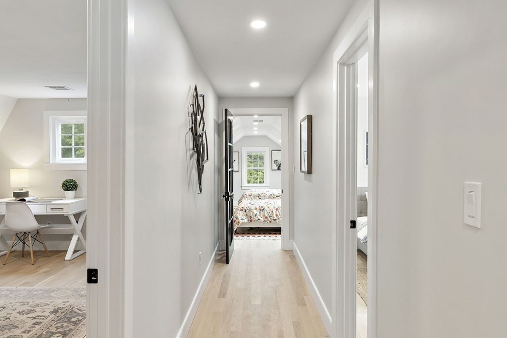 8 Longmeadow Road Weston, MA 02493 - Photo 25 of 39 a view of a hallway with wooden floor and a living room