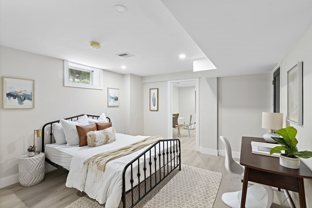 8 Longmeadow Road Weston, MA 02493 - Photo 33 of 39 a bedroom with a bed and a table in it
