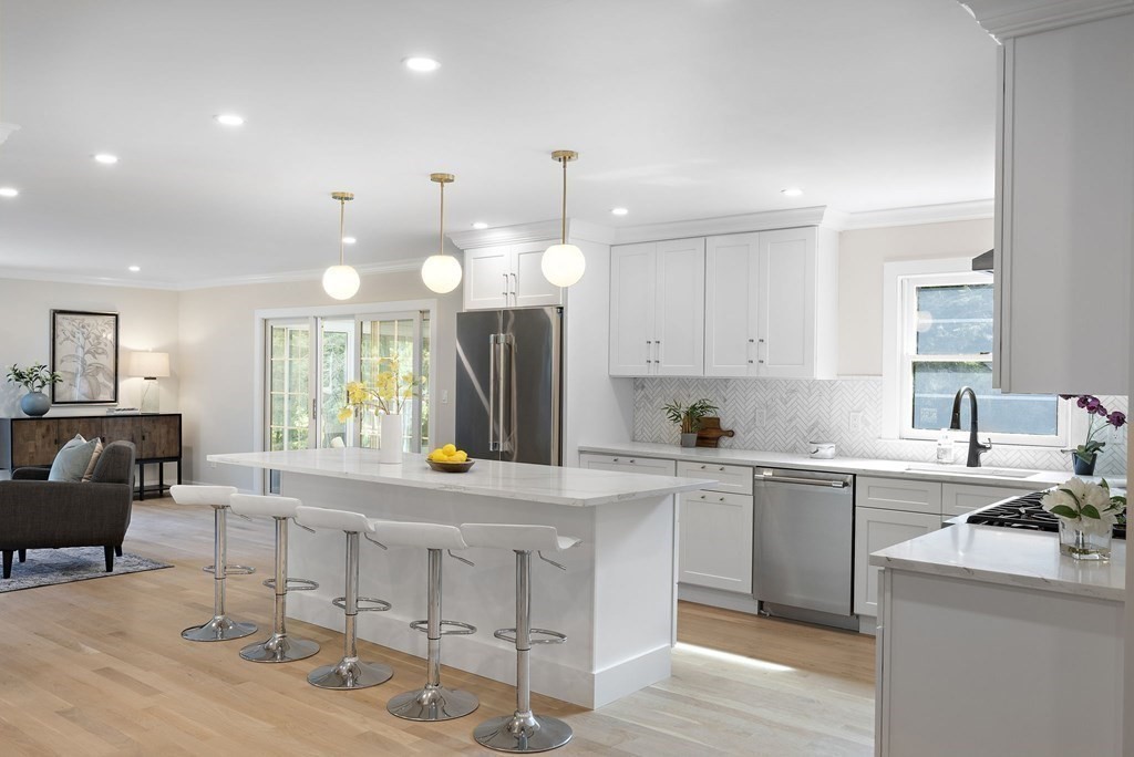 8 Longmeadow Road Weston, MA 02493 - Photo 5 of 39 a large white kitchen with a large island oven a sink stainless steel appliances and cabinets