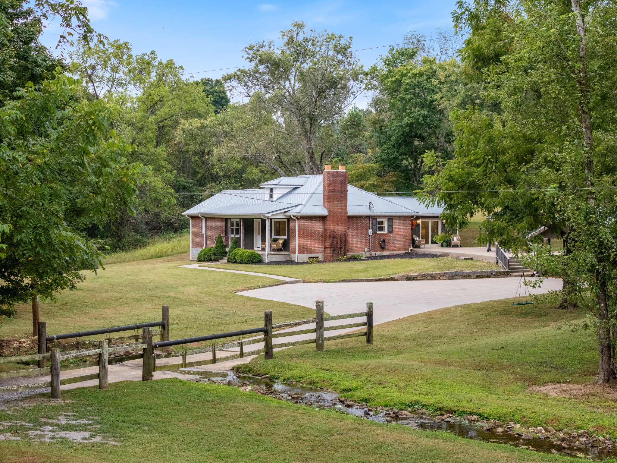 a front view of a house with swimming pool having outdoor seating