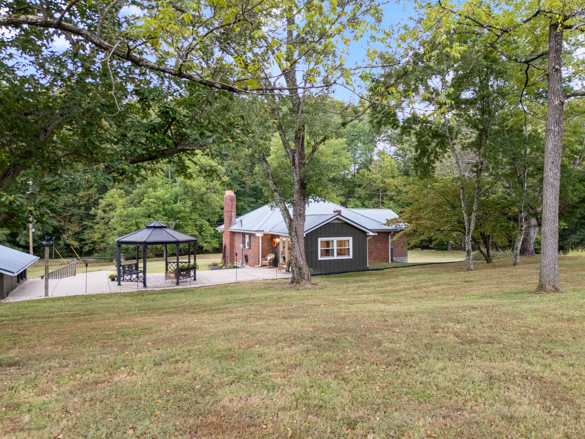 7770 Smith Road Primm Springs, TN 38476 - Photo 14 of 62 a front view of a house with garden