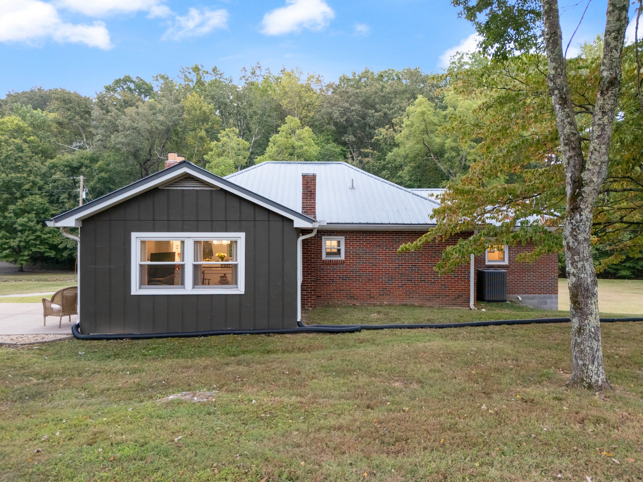 7770 Smith Road Primm Springs, TN 38476 - Photo 15 of 62 a front view of house with yard and trees in the background