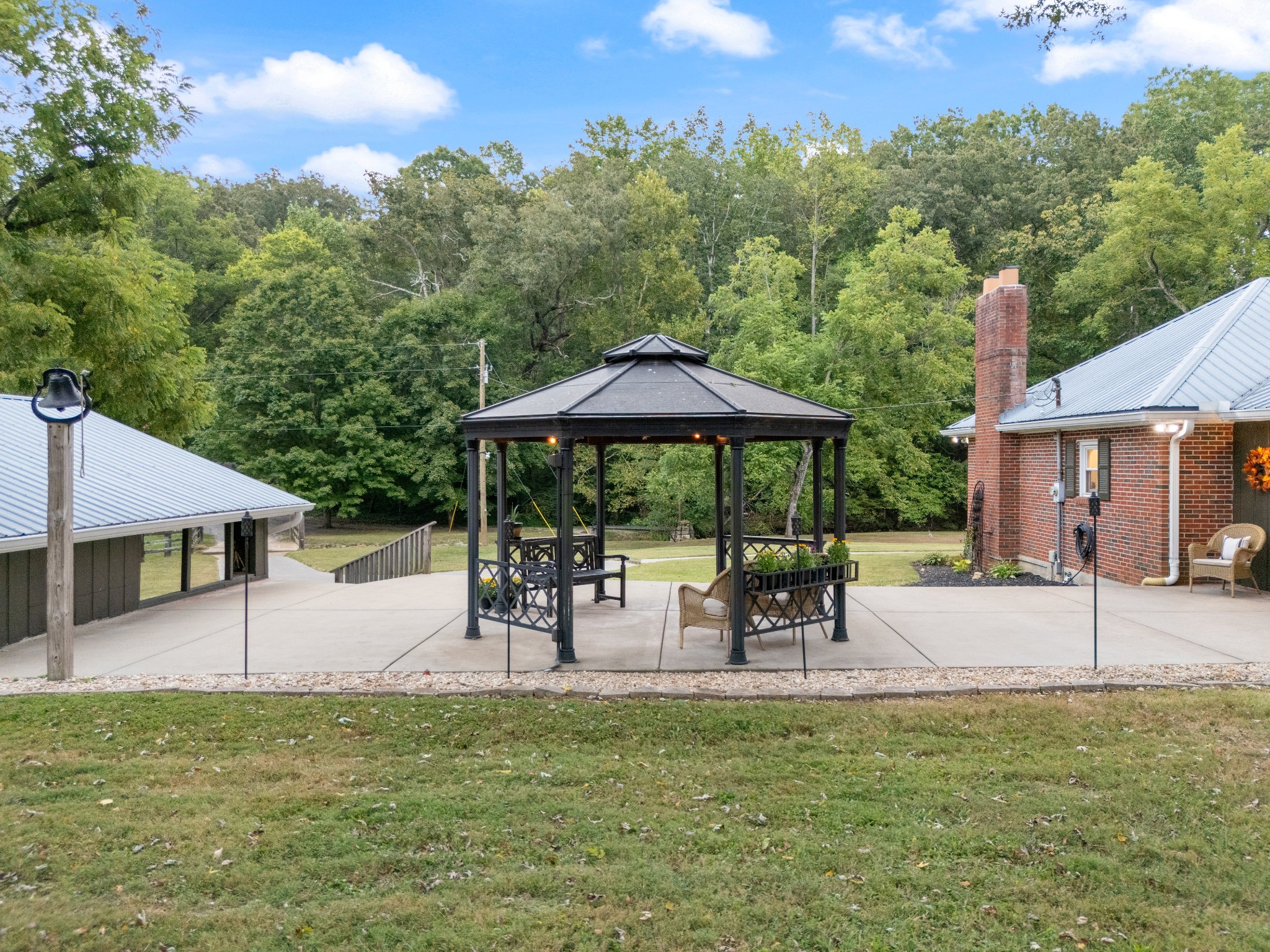 7770 Smith Road Primm Springs, TN 38476 - Photo 16 of 62 a view of a swimming pool with a table and chairs under an umbrella