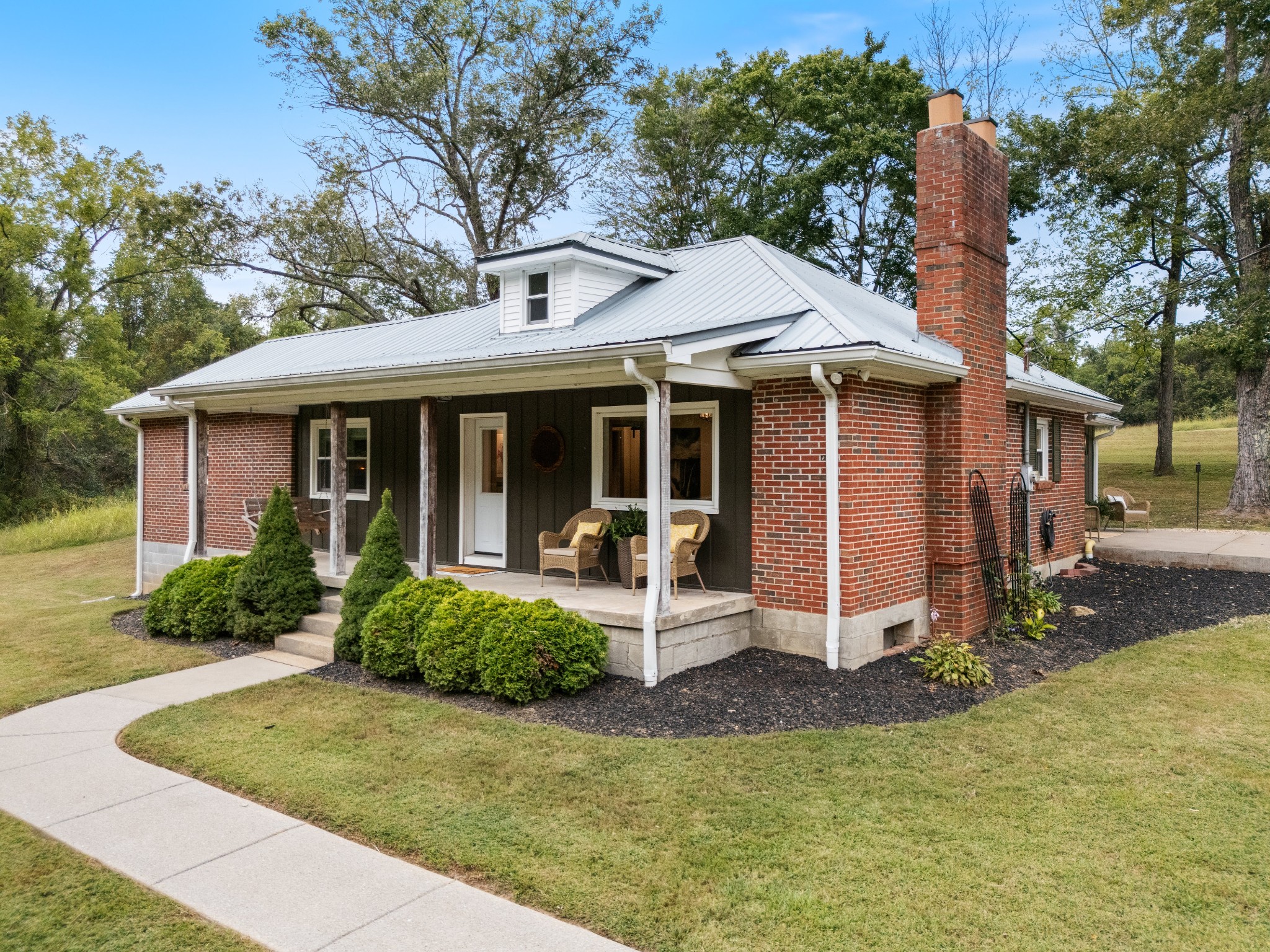 7770 Smith Road Primm Springs, TN 38476 - Photo 2 of 62 a view of a house with backyard sitting area and garden