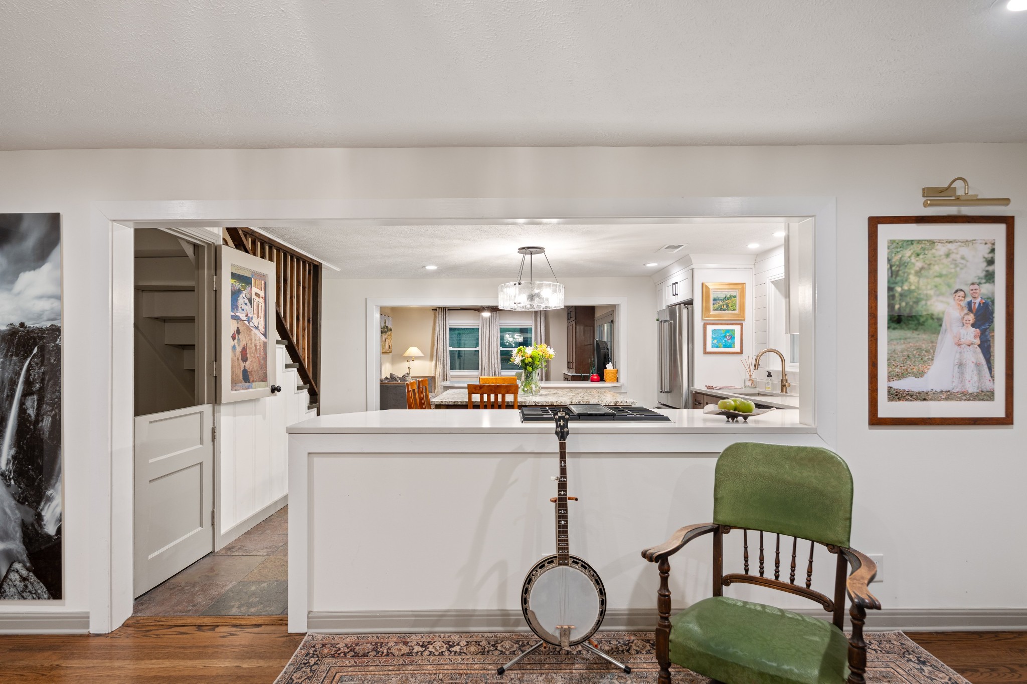 7770 Smith Road Primm Springs, TN 38476 - Photo 23 of 62 a kitchen with stainless steel appliances granite countertop a stove a refrigerator a dining table and chairs with wooden floor