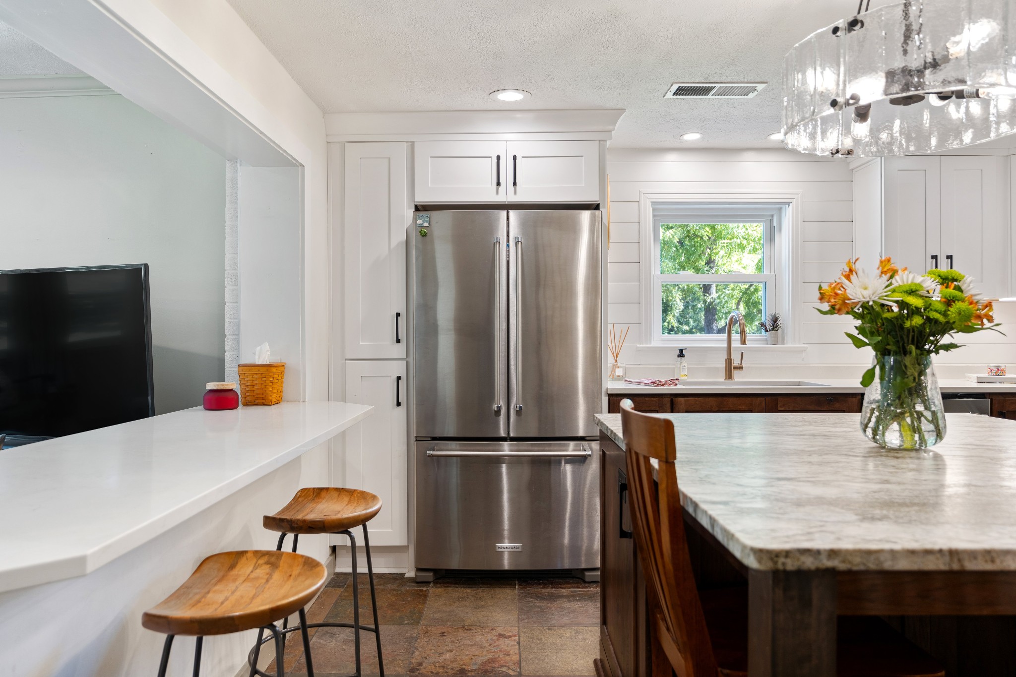 7770 Smith Road Primm Springs, TN 38476 - Photo 28 of 62 a kitchen with stainless steel appliances granite countertop a refrigerator a sink dishwasher a dining table and chairs with wooden floor