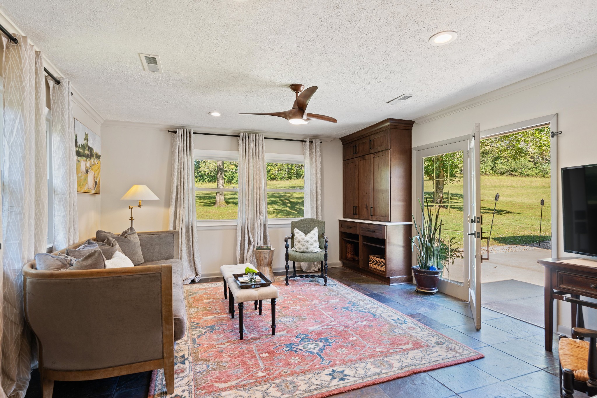7770 Smith Road Primm Springs, TN 38476 - Photo 32 of 62 a living room with furniture fireplace and a flat screen tv