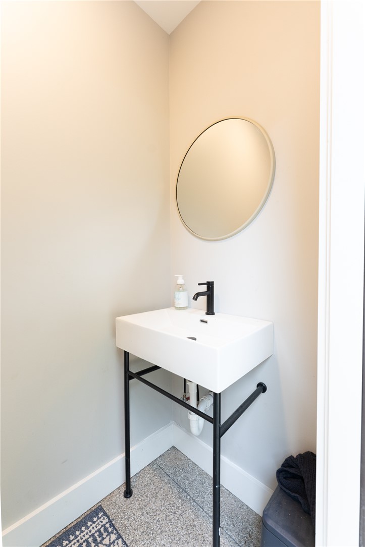 103 Riggs Drive Clemson, SC 29631 - Photo 49 of 50 A chic floating vanity and circular mirror create a minimalist and functional powder room.