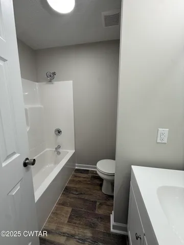 a bathroom with a sink a toilet and bathtub