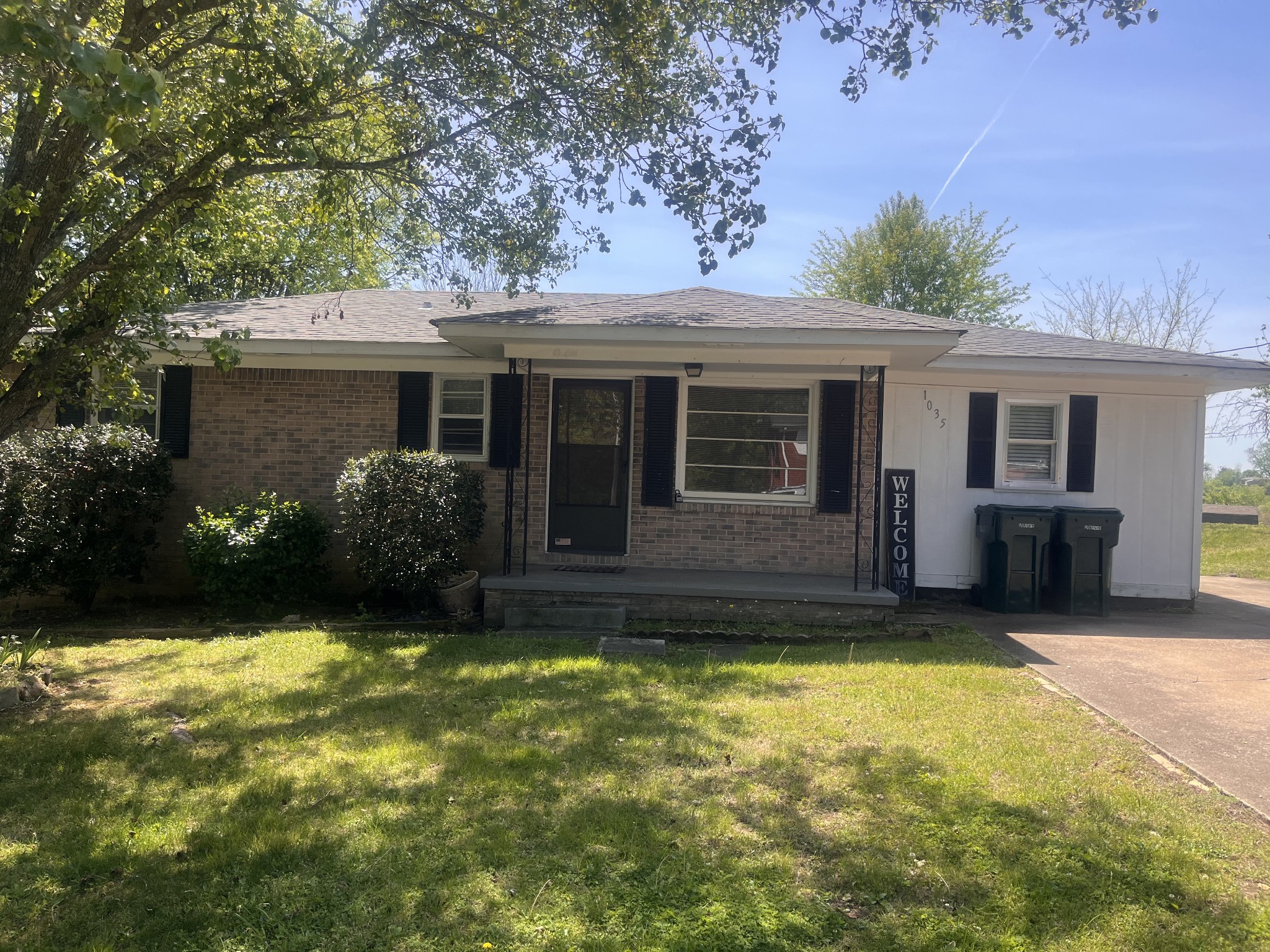 1035 North 3rd Street Pulaski, TN 38478 - Photo 1 of 17 a view of a house with a yard potted plants and a large tree