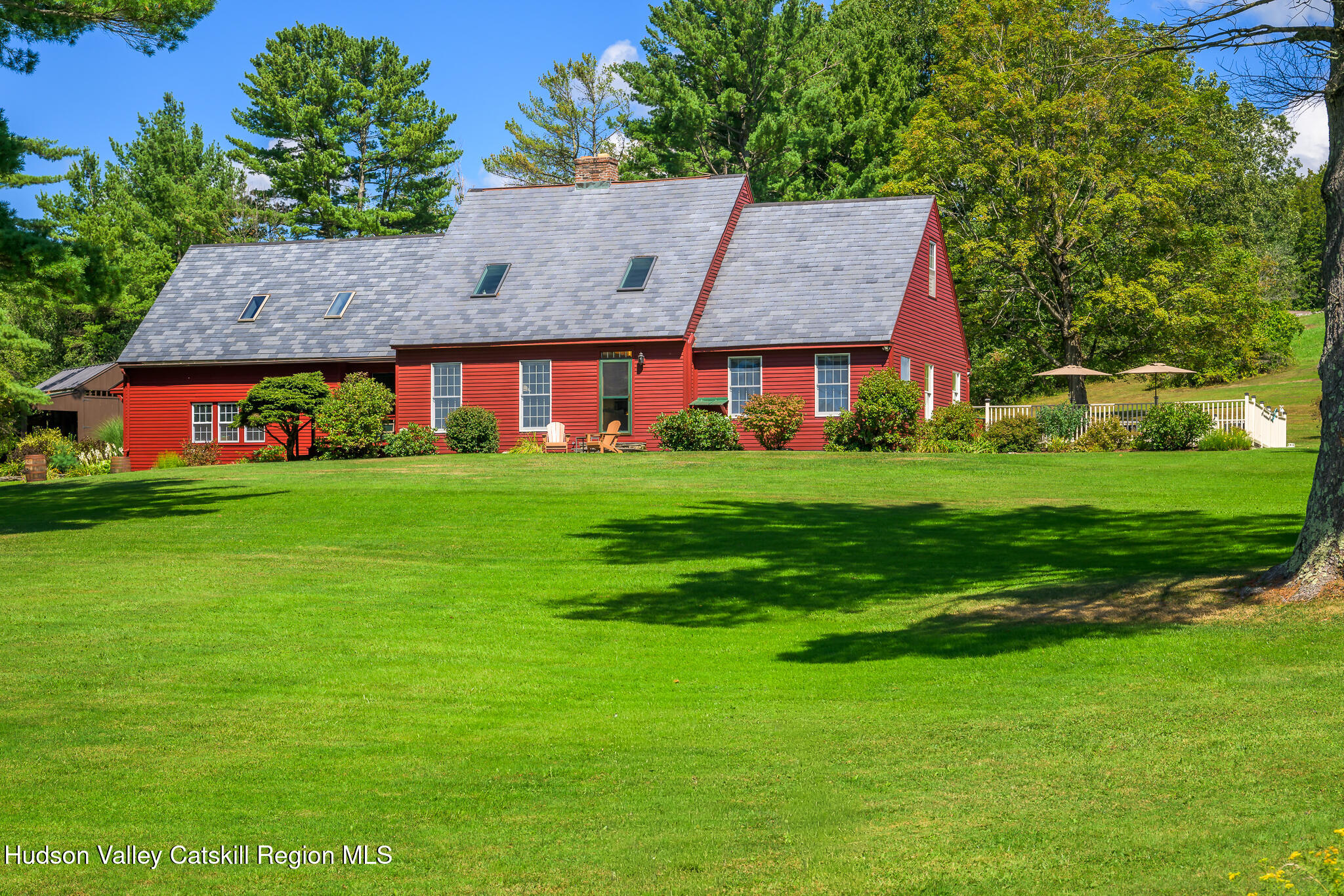 a view of a big house with a big yard and potted plants